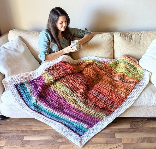 A wider shot of the woman blanket, showing the full blanket with a white border on it.