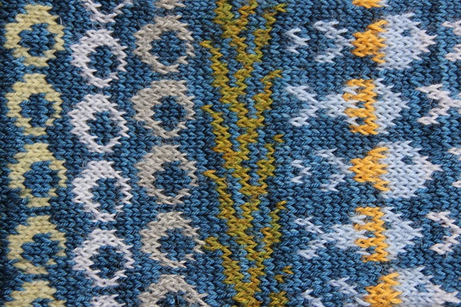 A different section of the cowl showing three column of bubbles, a different column of kelp, and a column of fish.